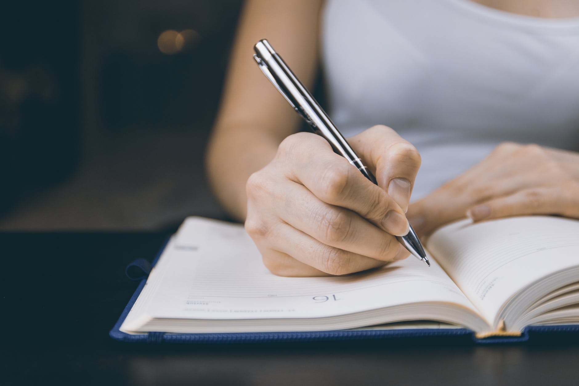 Stock image of woman writing in notebook